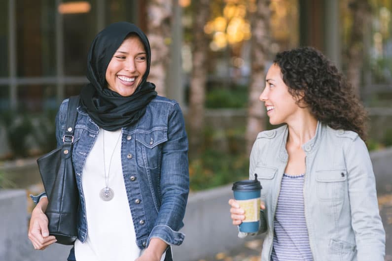 two women walking and talking